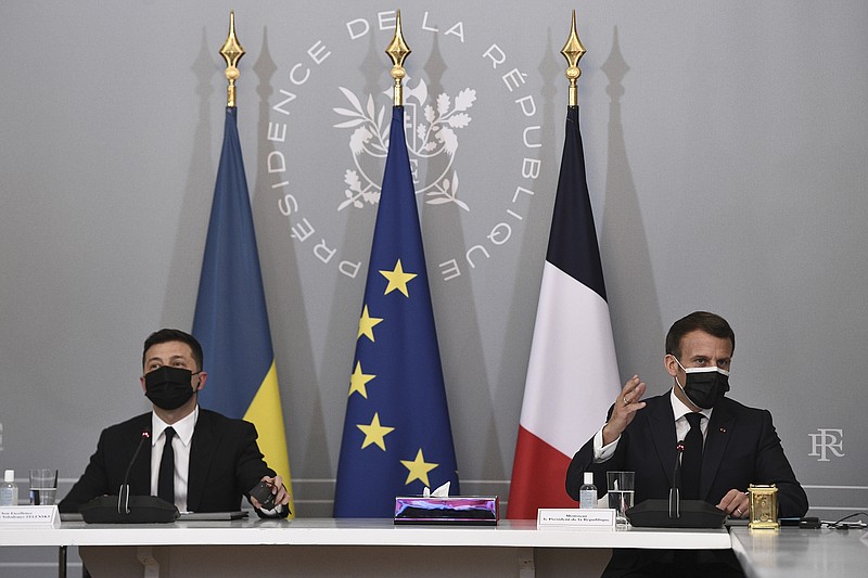 French President Emmanuel Macron, right, and Ukrainian President Volodymyr Zelenskyy hold a press conference following their meeting at the Elysee Palace in Paris Friday April 16, 2021. Ukrainian President Volodymyr Zelenskyy is in Paris for talks with French President Emmanuel Macron and German Chancellor Angela Merkel amid his country's growing tensions with neighboring Russia, which has deployed troops near its border with Ukraine. (Anne-Christine Poujoulat, Pool via AP)