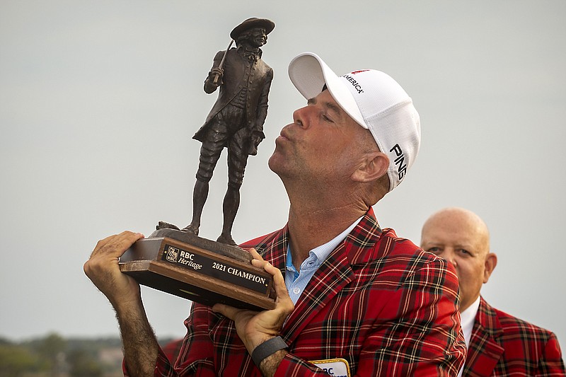 Stewart Cink kisses the championship trophy after winning the final round of the RBC Heritage golf tournament in Hilton Head Island, S.C., Sunday, April 18, 2021. (AP Photo/Stephen B. Morton)