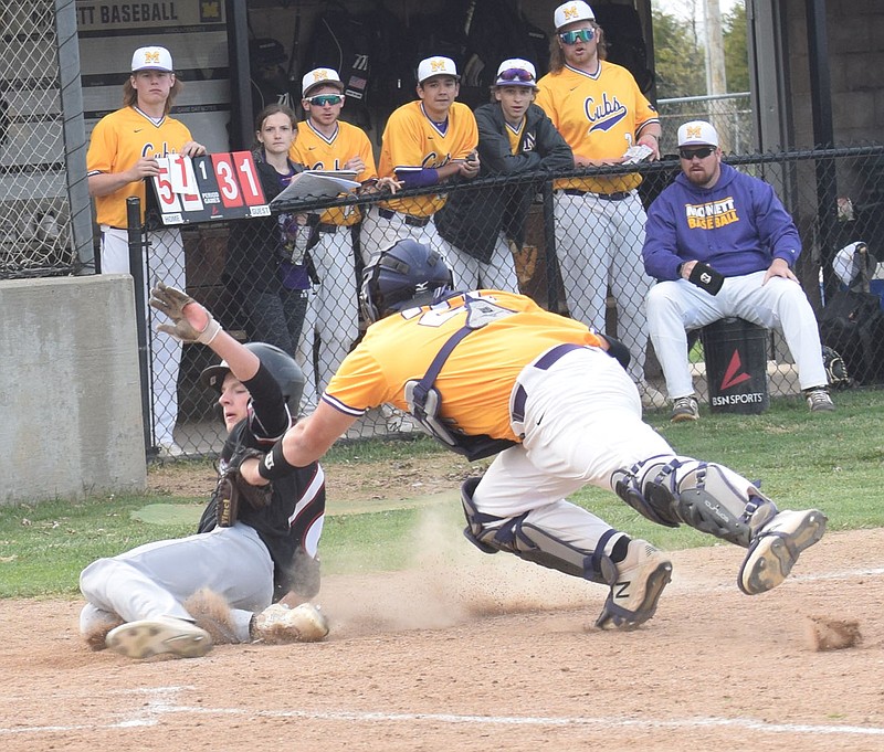 RICK PECK/SPECIAL TO MCDONALD COUNTY PRESS McDonald County's Jack Parnell gets tagged out by Monett catcher Tanner Wright despite trying to dive around the tag during the Mustangs 9-5 win on April 15 at Monett High School.