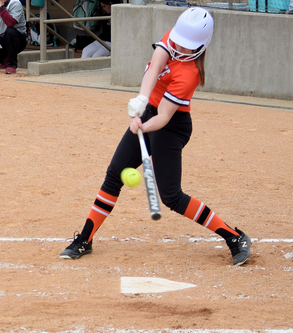 Westside Eagle Observer/MIKE ECKELS
Keeley Elsea makes contact with the softball, sending it deep into the outfield for a double during the Thursday night Gravette-Huntsville softball game at Lion softball field in Gravette. Elsea drove home two runs on this play.