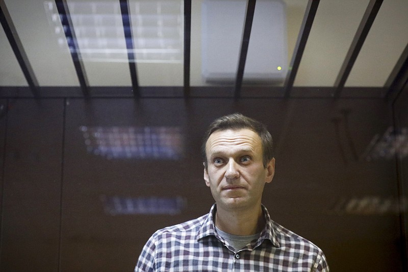 FILE - In this Feb. 20, 2021, file photo, Russian opposition leader Alexei Navalny stands in a cage in the Babuskinsky District Court in Moscow, Russia. (AP Photo/Alexander Zemlianichenko, File)