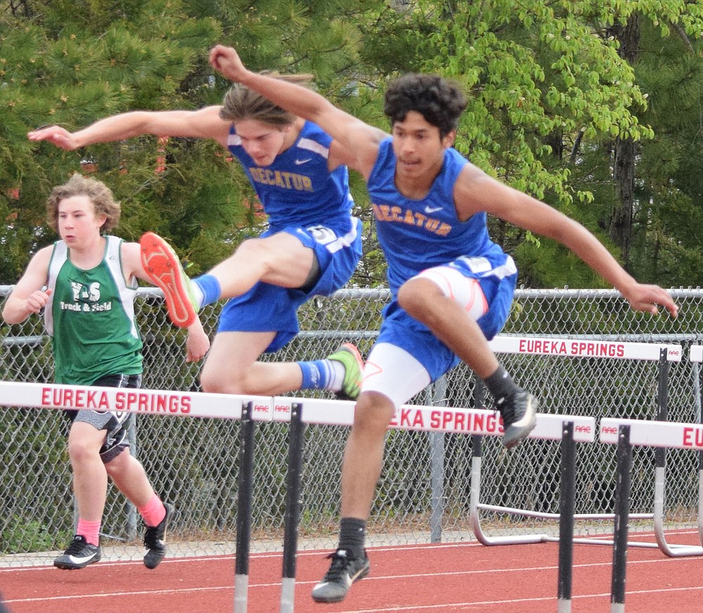 Westside Eagle Observer/MIKE ECKELS
Decatur's Brian Ruiz (right) and teammate Dayton McGarrah leap over the bars at nearly the same time during the 300 meter hurdles which were part of the 2A-1 Junior High District Track Meet in Eureka Springs Friday. Ruiz took first place and McGarrah took second in both the 110 and 300 meter hurdles, leading the Decatur boys to a second place finish in the meet.