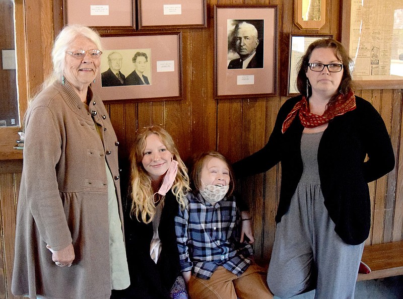 Westside Eagle Observer/MIKE ECKELS

The Hines family from the Houston, Texas area were in Decatur April 19 to find information about William Hines (pictured behind family) who was the station master at the Decatur depot from the late 1880's until his retirement in 1937. Martha Hines Morgan (left), the grand daughter of William Hines, lead the investigation while Makyla Morgan and Hunter Moon (both great-great grandchild) and Chelsea Morgan Moon (Martha's daughter) looks at some of the artifacts in the museum.