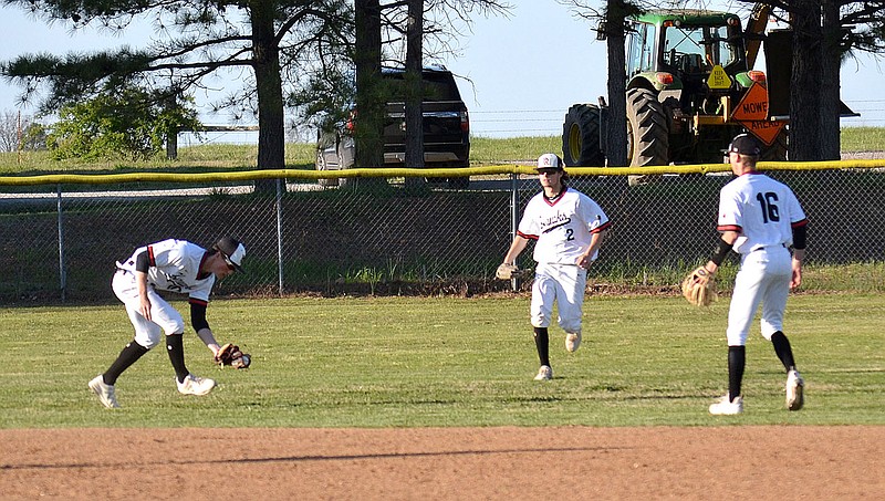 Blackhawk fielders rush to catch a fly ball batted by a Farmington Cardinal ball player Monday, April 19, 2021.