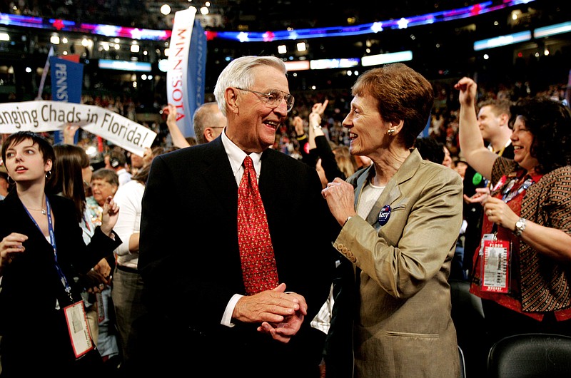FILE - In this Monday, July 26, 2004, file photo, former Vice President Walter Mondale smiles with his wife, Joan, in the Minnesota delegation during the Democratic National Convention at the FleetCenter in Boston. Mondale, a liberal icon who lost the most lopsided presidential election after bluntly telling voters to expect a tax increase if he won, died Monday, April 19, 2021. He was 93. (AP Photo/Amy Sancetta, File)