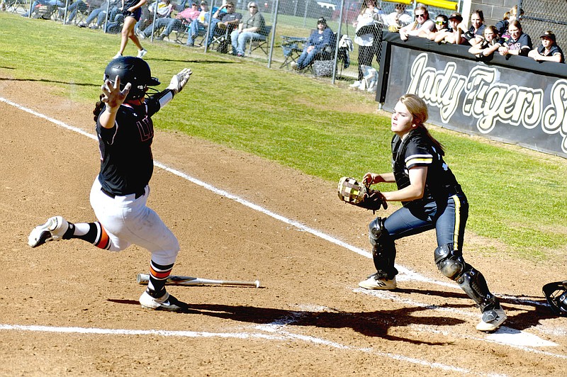 MARK HUMPHREY  ENTERPRISE-LEADER/Prairie Grove senior catcher Karaline McConnell records a force out at the plate as a Gravette base runner approaches. Prairie Grove won the 4A-1 softball game by a 9-6 score at home on Monday, April 19.