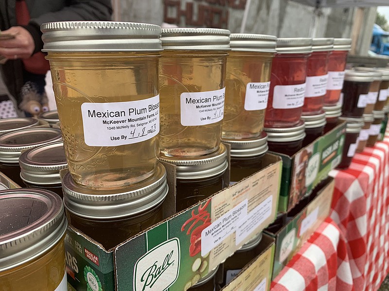 SALLY CARROLL/SPECIAL TO MCDONALD COUNTY PRESS McKeever Mountain Farms offered a variety of unique jelly flavors, such as Mexican Plum Blossom, Hillbilly Champagne Apple Pie and Lilac, at the Farmers Market event on Saturday. Mountain Happenings at Sim's Corner hosts the Farmers Market.