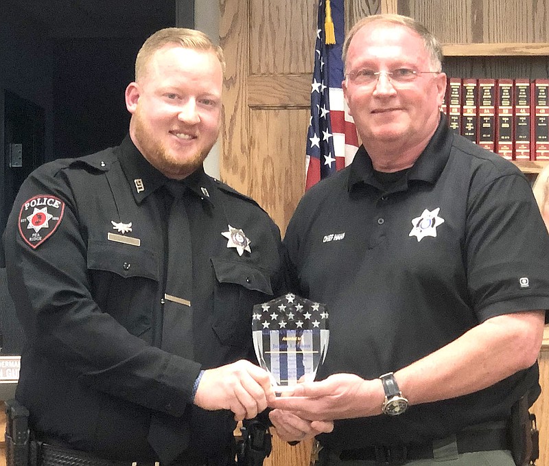Pea Ridge Police Chief Lynn Hahn (right) presented a life-saving award to officer Justin Lawson at the Pea Ridge City Council meeting last week honoring Lawson for his quick thinking and use of Narcan that saved the life of a woman who had accidentally taken an overdose.