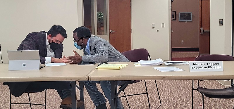 Attorney Cody Keys, who represents the Urban Renewal Agency, consults with Executive Director Maurice Taggart at Tuesday evening's commission meeting. (Pine Bluff Commercial/Eplunus Colvin)