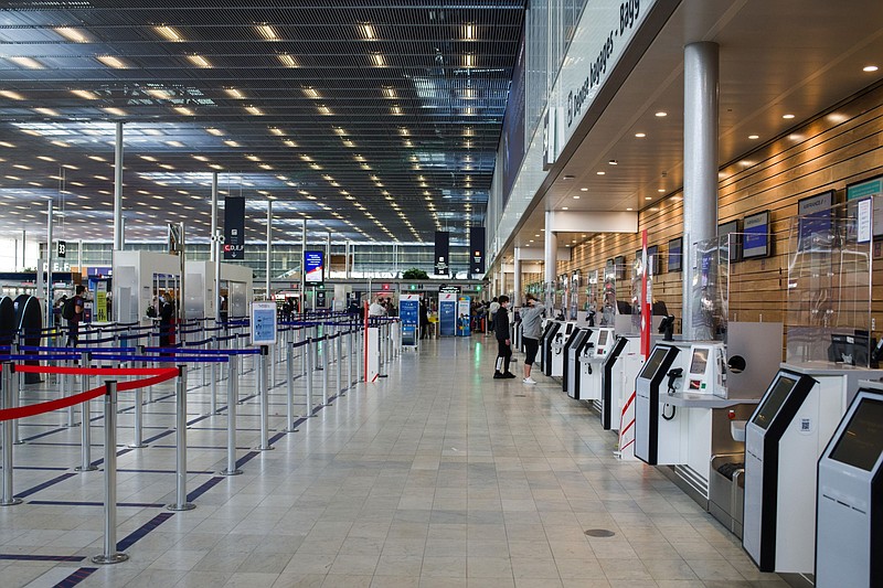 Travelers at a baggage drop and check-in area in Terminal 3 at Orly Airport in Paris on April 9, 2021. MUST CREDIT: Bloomberg photo by Nathan Laine.