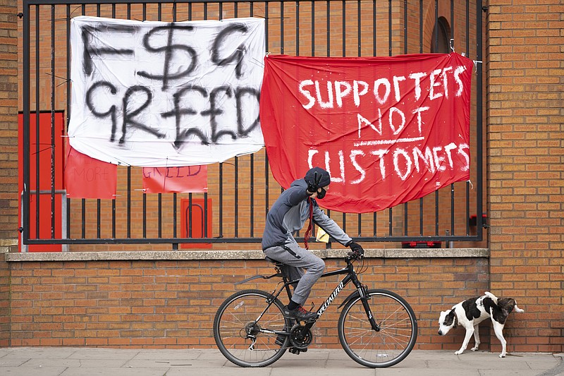 Banners are seen outside Liverpool's Anfield Stadium after the collapse of English involvement in the proposed European Super League, Liverpool, England, Wednesday, April 21, 2021. Liverpool owner John W Henry has apologised to the club's supporters for the "disruption" caused by the proposed European Super League (ESL). (AP Photo/Jon Super)
