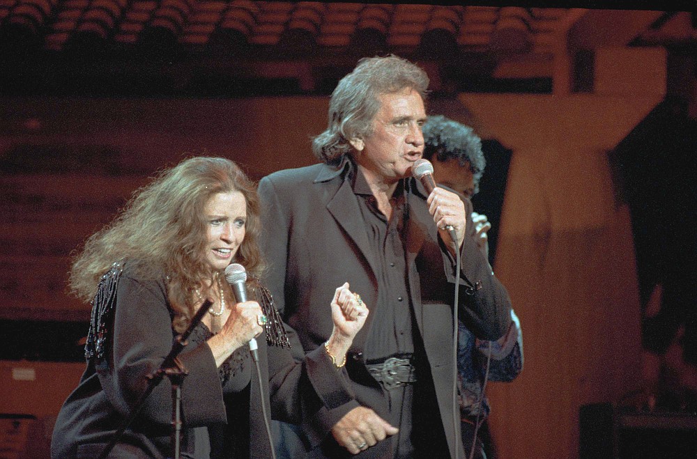 FILE - In this Oct. 16, 1992, file photo, singers Johnny Cash and his wife June Carter Cash perform at New York's Madison Square Garden. The Man in Black is about to get his own day in Arkansas. The Arkansas House on Tuesday, April 20, 2021, gave unanimous final approval to a bill that would make Feb. 26 "Johnny Cash Day," sending it to Gov. Asa Hutchinson, who plans to sign it. AP Photo/Ron Frehm, File)