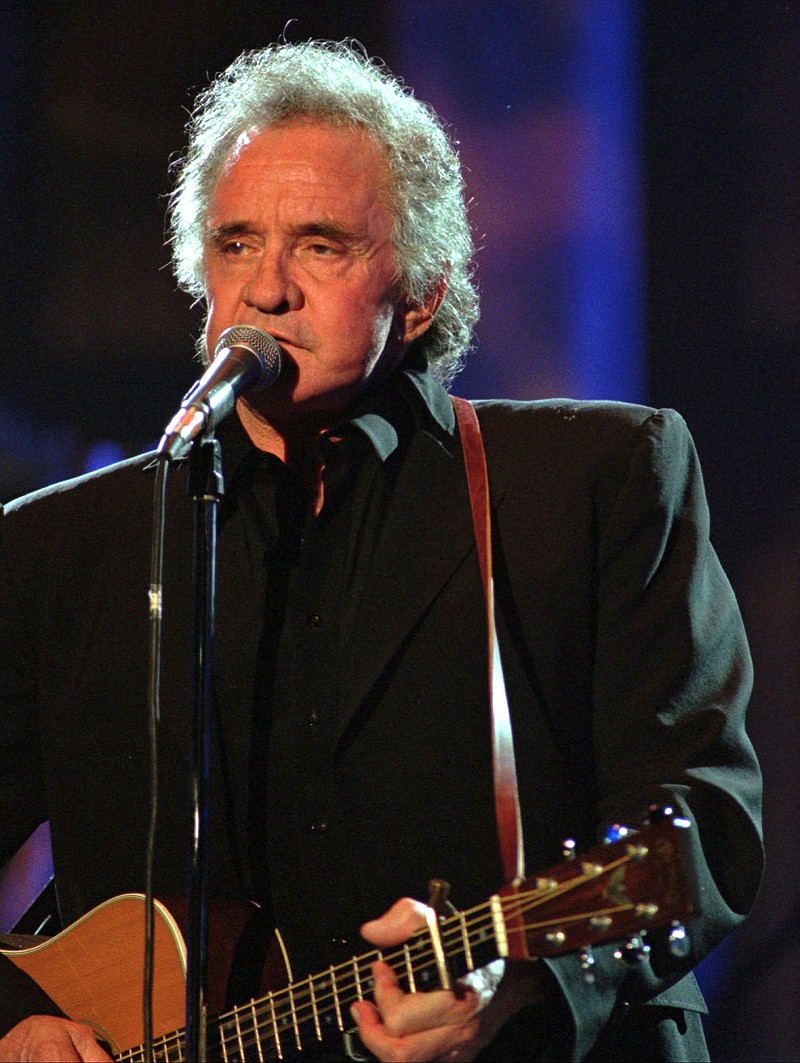 FILE - In this Sept. 2, 1995, file photo, singer Johnny Cash performs during his segment of the Concert for the Rock and Roll Hall of Fame, in Cleveland. The Man in Black is about to get his own day in Arkansas. The Arkansas House on Tuesday, April 20, 2021, gave unanimous final approval to a bill that would make Feb. 26 "Johnny Cash Day," sending it to Gov. Asa Hutchinson, who plans to sign it. (AP Photo/Mark Duncan, File)