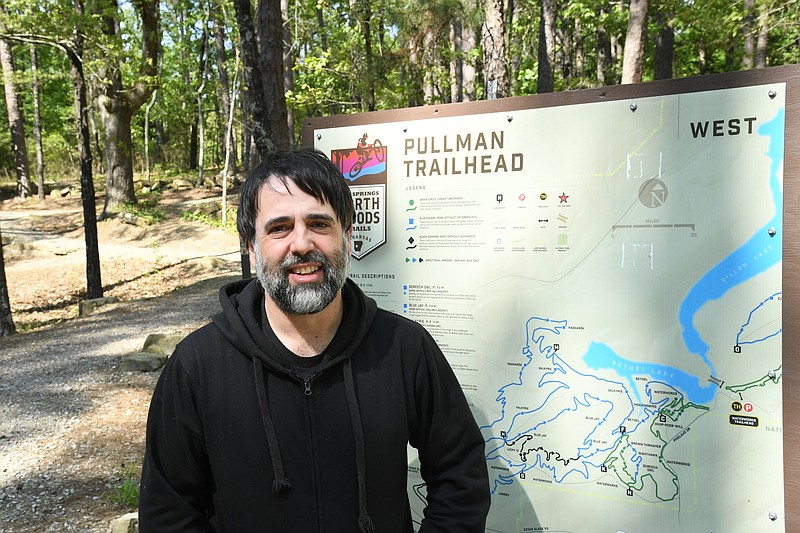 Sonny Kay, executive director of Low Key Arts, stands at the Pullman Trailhead, which is where LKA will lead a group hike in May. - Photo by Tanner Newton of The Sentinel-Record