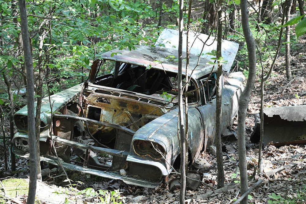 An old car sits in the woods off Pullman Trail. Low Key Arts will partner with Hot Springs National Park to hold a group hike on the trail, where a park ranger will tell the history of the park. - Photo by Tanner Newton of The Sentinel-Record