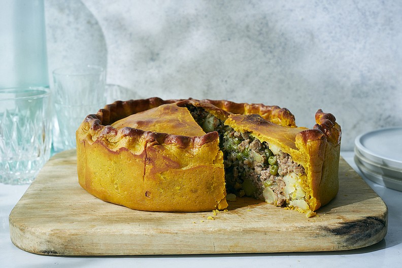 Food personality Nadiya Hussain riffs on a classic Victorian-era hot water pastry crust for the base of her turmeric-rich Samosa Pie. (The New York Times/David Malosh)