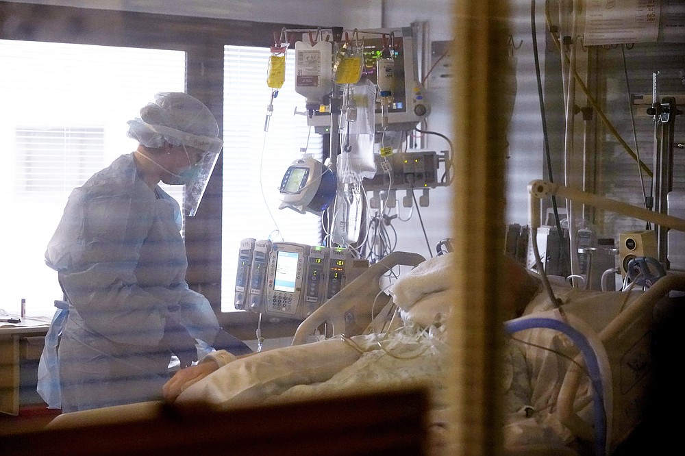 The Associated Press
Registered nurse Andraya Zelle treats a patient in the COVID intensive care unit at UW Medical Center-Montlake in Seattle on Jan. 26.