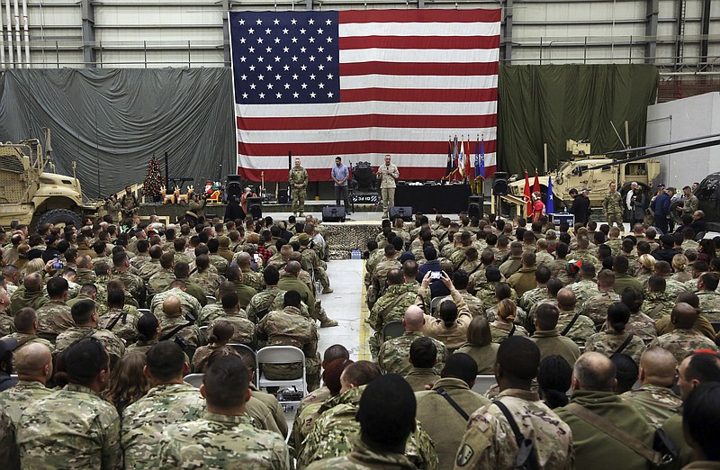 FILE- in this Sunday, Dec. 24, 2017, photo, Gen. Joseph Dunford, chairman of the Joint Chiefs of Staff speaks during a ceremony on Christmas Eve at a U.S. airfield in Bagram, north of Kabul, Afghanistan. The U.S. military has begun shipping equipment and winding down contracts with local service providers ahead of the May 1 start of the final phase of its military pullout from Afghanistan, a U.S. Defense Department official said Thursday, April 22, 2021.  (AP Photo/Rahmat Gul, File)