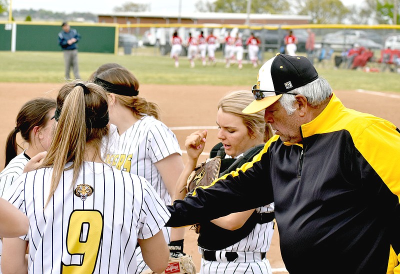 MARK HUMPHREY  ENTERPRISE-LEADER/Prairie Grove head softball coach Dave Torres breaks a team huddle in between innings. The Lady Tigers lost 11-1 to their rivals from Farmington in Thursday's 4A-1 Conference regular season finale.