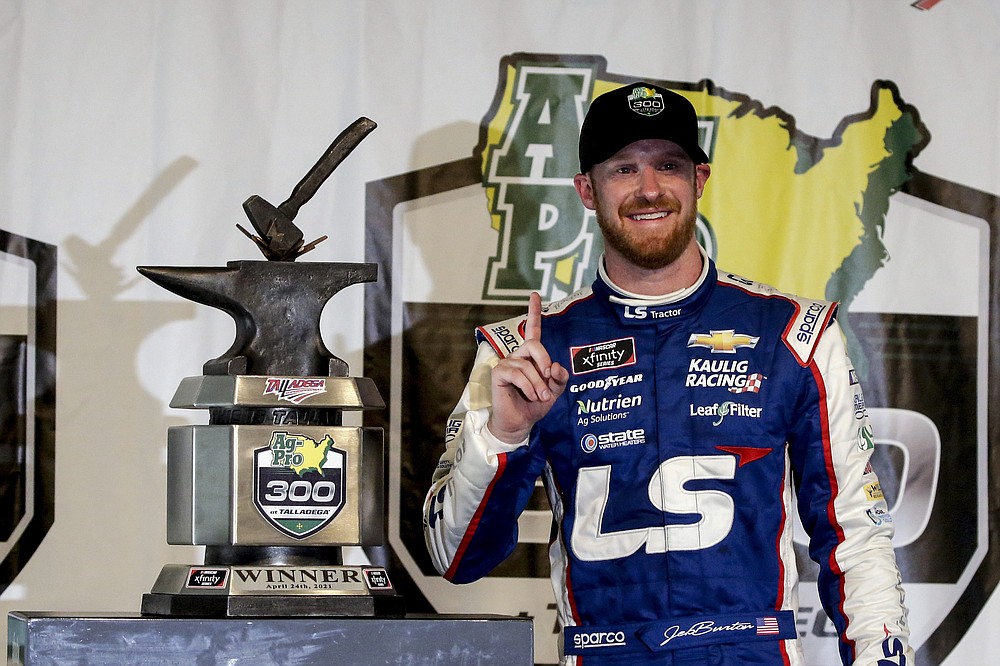 Jeb Burton smiles after winning the rain-shortened NASCAR Xfinity Series auto race at Talladega Superspeedway on Saturday, April 24, 2021, in Talladega, Ala. (AP Photo/Butch Dill)