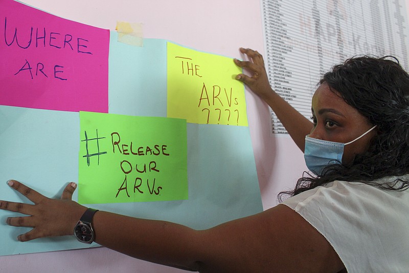 A protester holds a placard during a demonstration over shortages of anti-retroviral (ARV) medicines, organized by people living with HIV or AIDS, sex-workers, members of the LGBT community, and their supporters, in the port city of Mombasa, Kenya Thursday, April 22, 2021. Kenyans living with HIV say their lives are in danger due to a shortage of anti-retroviral drugs donated by the United States amid a dispute between the U.S. aid agency and the Kenyan government. (AP Photo)