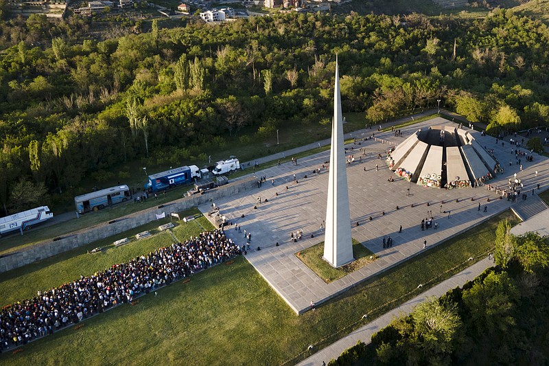 People lineup to lay flowers at the monument to the victims of mass killings by Ottoman Turks, to commemorate the 106th anniversary of the massacre, in Yerevan, Armenia, Saturday, April 24, 2021. Armenia's leader is praising President Joe Biden's recognition of the deaths of 1.5 million Armenians in Ottoman Turkey as genocide, calling it "a powerful step." Armenia marks the day as the anniversary of the 1915 rounding up of some 250 Armenian intellectuals, regarded as the first step in the killings that lasted until 1923. (Davit Abrahamyan/PAN Photo via AP)