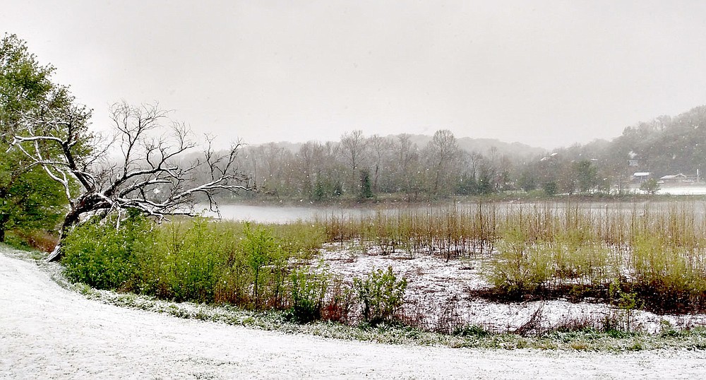 Keith Bryant/The Weekly Vista
Lake Bella Vista sits surrounded by snow, with ongoing precipitation giving the appearance of fog during last week's unusual spring snowstorm.