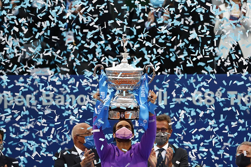 Rafael Nadal of Spain holds the trophy after winning the Godo final against Stefanos Tsitsipas of Greece in Barcelona, Spain, Sunday. Nadal won 6-4, 6-7, 7-5. - Photo by Joan Monfort of The Associated Press