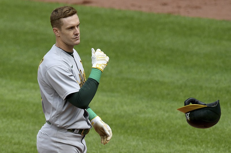 Oakland Athletics' Mark Canha reacts after striking out against the Baltimore Orioles in the eighth inning of a baseball game, Sunday, April 25, 2021, in Baltimore. (AP Photo/Will Newton)