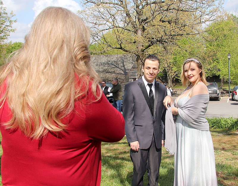 LYNN KUTTER ENTERPRISE-LEADER
Kristi Hassell takes photos of her son, Kellen Hassell, a junior at Prairie Grove High School, and his prom date, Eve Johnson, who is homeschooled, at Prairie Grove Battlefield State Park. Hundreds of parents and high school students were at the park Saturday to take prom pictures before the event that night at the high school commons area. Last year proms were canceled because of covid-19 concerns.