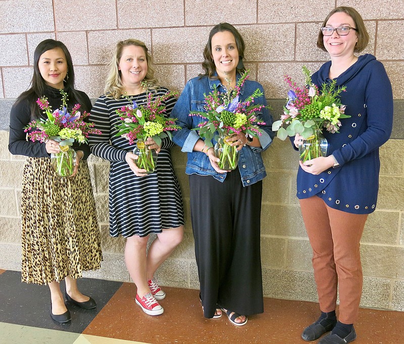 Westside Eagle Observer/SUSAN HOLLAND
Teachers of the Year for 2020-2021 at Gravette schools display the bouquets of flowers they were given as they were honored at the April meeting of the Gravette school board. The teachers were introduced at the meeting Monday evening, April 19, by Superintendent Maribel Childress. Pictured are Sue Cluck, Teacher of the Year for Gravette High School; Jackie Galyean, Gravette Middle School winner; Emily Ensor, winner at Gravette Upper Elementary; and Amber Sisemore, Teacher of the Year at Glenn Duffy Elementary.
