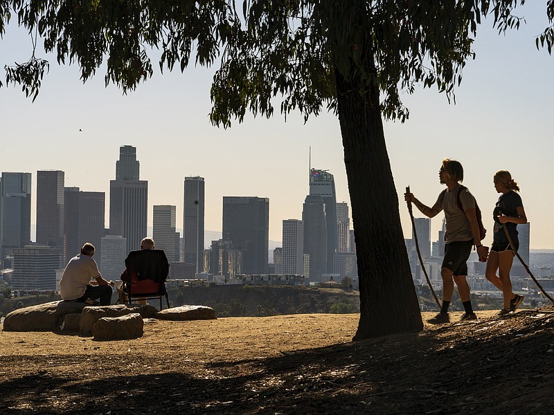 FILE - In this Monday, Jan. 11, 2021, file photo, people overlook the skyline of Los Angeles. California is losing a U.S. House seat for the first time, dropping its delegation from 53 to 52 members. That's according to Census Bureau population data released Monday, April 26, 2021, that determines how the nation's 435 House seats are allocated. (AP Photo/Damian Dovarganes, File)