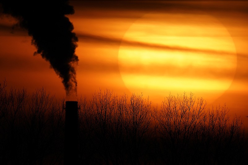 FILE - In this Feb. 1, 2021 file photo, emissions from a coal-fired power plant are silhouetted against the setting sun in Independence, Mo. President Joe Biden is convening a coalition of the willing, the unwilling, the desperate-for-help and the avid-for-money for a two-day summit aimed at rallying the world’s worst polluters to do more to slow climate change. Biden’s first task when his virtual summit opens Thursday is to convince the world that the United States is both willing and able isn’t just willing to meet an ambitious new emissions-cutting pledge, but also able.  (AP Photo/Charlie Riedel, File)