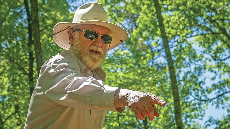 Ralph Howard gestures towards an endangered plant colony at Whispering Hills Memorial Nature Preserve, Monday, April 19, 2021 in LaGrange, Ga. Whispering Hills has begun operating a green cemetery, an environmentally conscious death care practice. (Madeleine Cook/Ledger-Enquirer via AP)