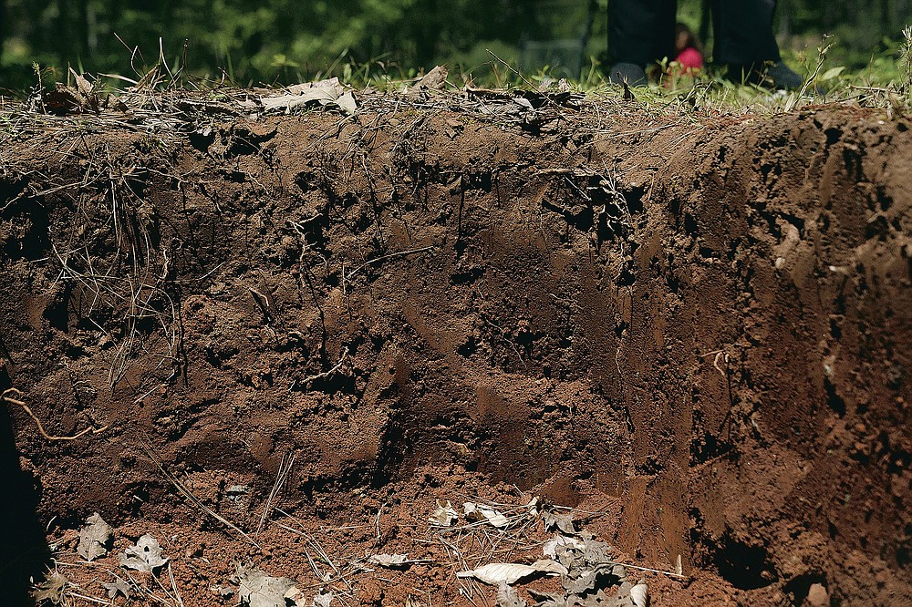 A grave dug as an example of a green cemetery site at Whispering Hills Memorial Nature Preserve, Monday, April 19, 2021 in LaGrange, Ga. Whispering Hills has begun operating a green cemetery, an environmentally conscious death care practice. (Madeleine Cook/Ledger-Enquirer via AP)