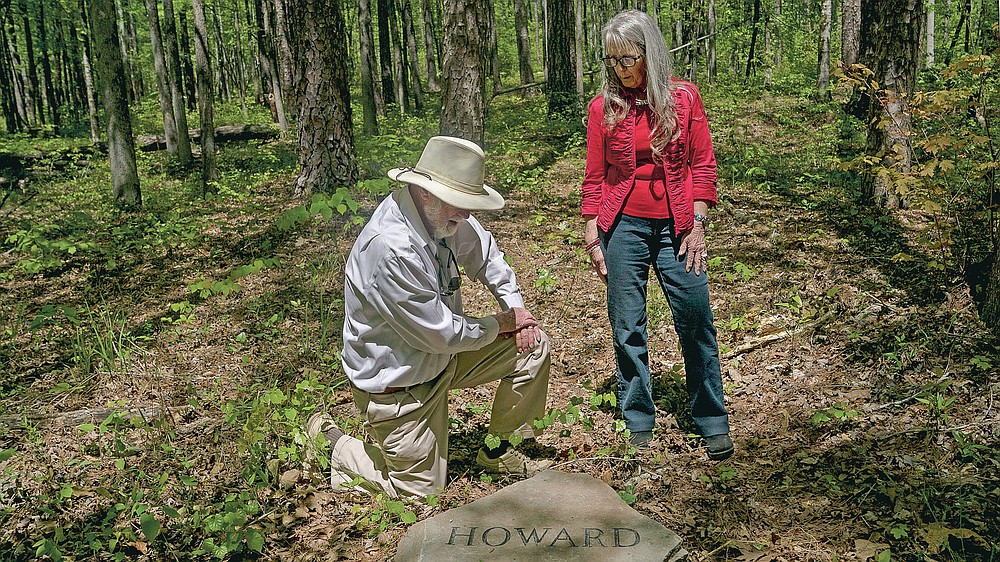 Siblings Ralph and Jean Howard pause at their headstone in the Whispering Hills Memorial Nature Preserve, Monday, April 19, 2021 in LaGrange, Ga. Whispering Hills has begun operating a green cemetery, an environmentally conscious death care practice. (Madeleine Cook/Ledger-Enquirer via AP)