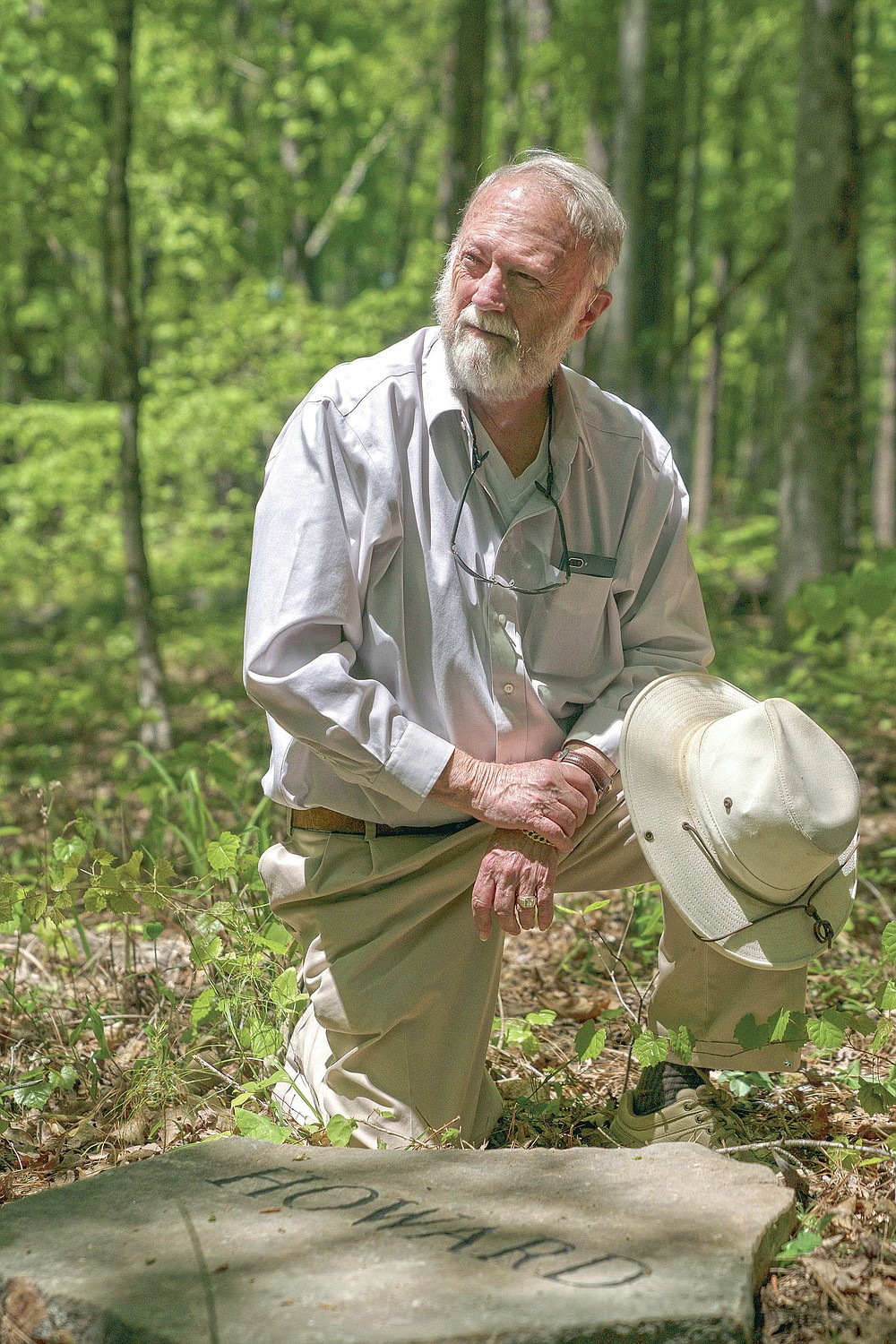 Ralph Howard pauses at his headstone at Whispering Hills Memorial Nature Preserve, Monday, April 19, 2021 in LaGrange, Ga. Whispering Hills has begun operating a green cemetery, an environmentally conscious death care practice. (Madeleine Cook/Ledger-Enquirer via AP)