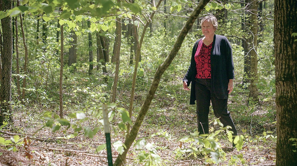 Jeanette Little walks through the Whispering Hills Memorial Nature Preserve, Monday, April 19, 2021 in LaGrange, Ga. Whispering Hills has begun operating a green cemetery, an environmentally conscious death care practice. Little has chosen to be buried there. (Madeleine Cook/Ledger-Enquirer via AP)