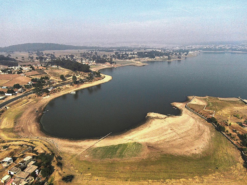 An aerial view of Villa Victoria Dam, the main water supply for Mexico City residents, on the outskirts of Toluca, Mexico Thursday, April 22, 2021. Drought conditions now cover 85% of Mexico, and in areas around Mexico City and Michoacán, the problem has gotten so bad that lakes and reservoirs are drying up. (AP Photo/Fernando Llano)