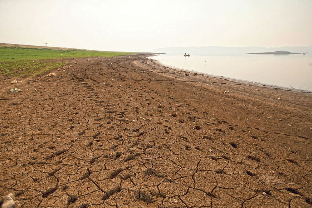 Cracked earth lines the banks of the Villa Victoria Dam, the main water supply for Mexico City residents, on the outskirts of Toluca, Mexico, Thursday, April 22, 2021. The mayor of Mexico City said Mexico's drought was the worst in 30 years. (AP Photo/Fernando Llano)
