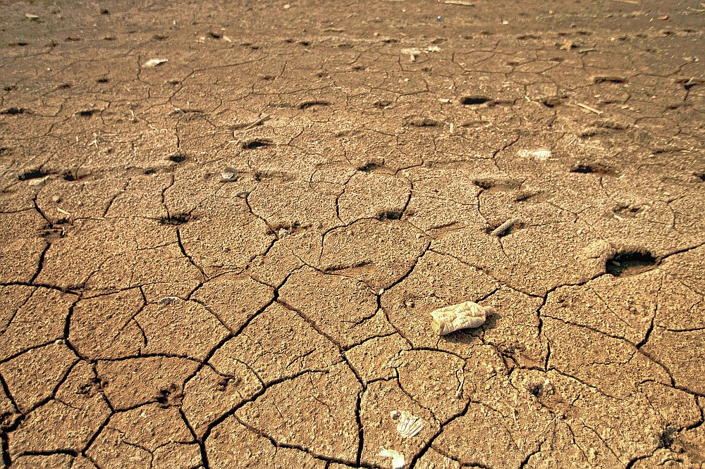 Cracked earth lines the banks of the Villa Victoria Dam, the main water supply for Mexico City residents, on the outskirts of Toluca, Mexico, Thursday, April 22, 2021. The mayor of Mexico City said Mexico's drought was the worst in 30 years. (AP Photo/Fernando Llano)