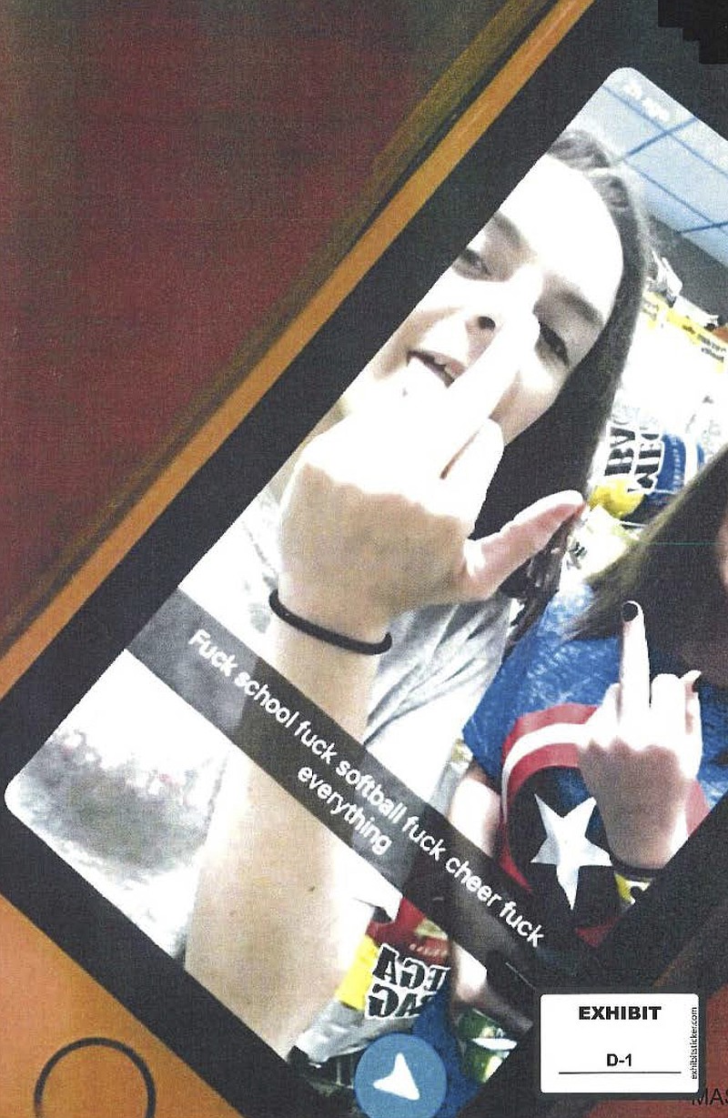 EDS NOTE: OBSCENITY - This photo provided by the American Civil Liberties Union, which was presented as evidence to the U.S. Supreme Court, shows a screenshot of a Snapchat post by Brandi Levy, left, in which Levy and her classmate raise their middle fingers as they pose in a convenience store in Mahonoy City, Pa., above a profanity-laced message written by Levy. The posting has ended up before the Supreme Court in the most significant case on student speech in more than 50 years. At issue in arguments to be heard Wednesday, April 28, 2021, via telephone, is whether public schools can discipline students over something they say off-campus. (Brandi Levy/American Civil Liberties Union via AP)