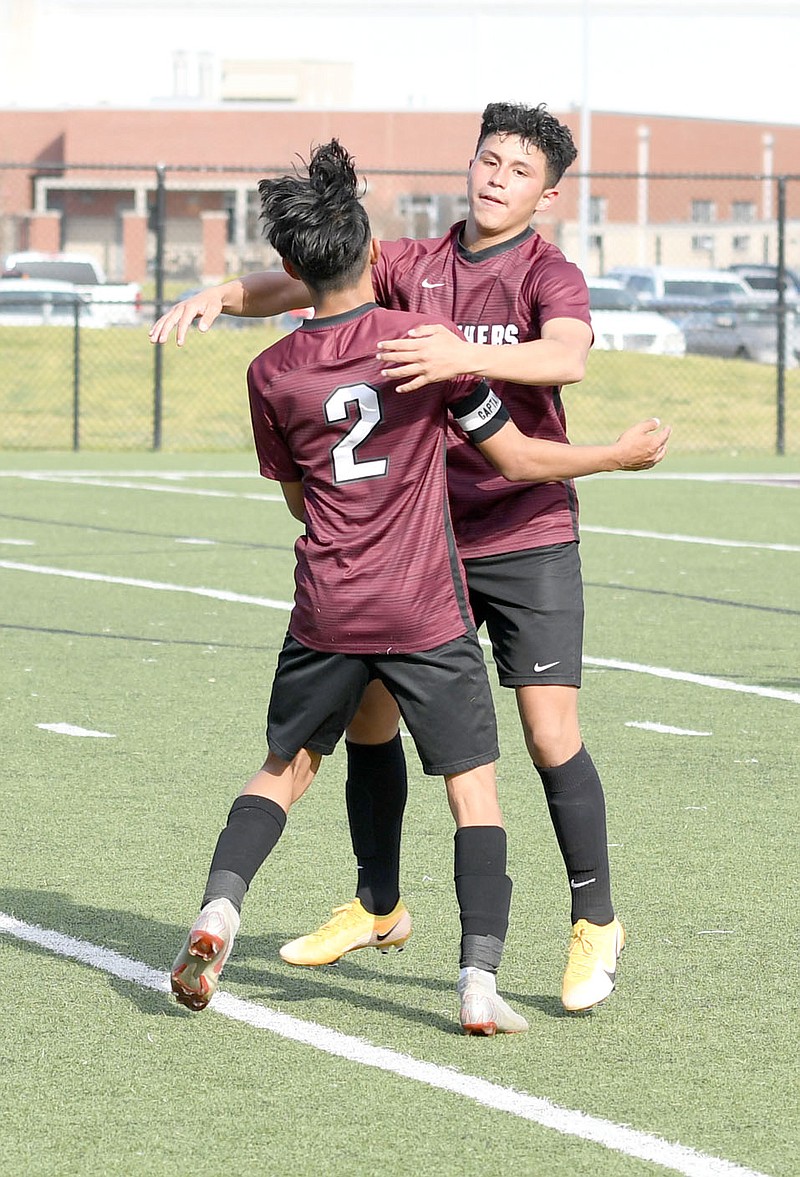 Bud Sullins/Special to the Herald-Leader
Junior Garza, No. 2) and Ivan Sandoval embrace after Sandoval assisted on Franklin Cortez's goal in the second half of Siloam Springs' 2-0 win against Greenbrier on Monday at Panther Stadium.