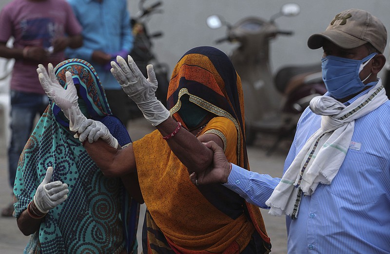 A relative of a patient who died of COVID-19, mourns outside a government COVID-19 hospital in Ahmedabad, India, Tuesday, April 27, 2021. Coronavirus cases in India are surging faster than anywhere else in the world. (AP Photo/Ajit Solanki)