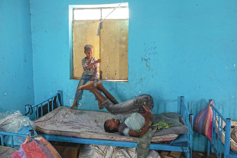 Tigrayan 5-year-old refugee Micheale Gebremariam, left, plays with a friend inside his family's shelter in Hamdayet, eastern Sudan, near the border with Ethiopia, on March 21, 2021. (AP Photo/Nariman El-Mofty)