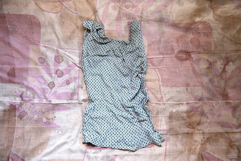 A handmade dress for 4-month-old Tigrayan twins Aden and Turfu Gebremariam, made from cloth belonging to their deceased mother, Letay, is seen inside the family's shelter in Hamdayet, eastern Sudan, near the border with Ethiopia, on March 14, 2021. Letay experienced a seemingly normal pregnancy in the Tigrayan region of Ethiopia. But ten days after giving birth to the twins, she passed away. (AP Photo/Nariman El-Mofty)