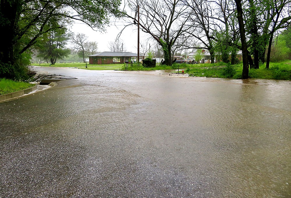 Westside Eagle Observer/RANDY MOLL
Water overflowed the roadway at the junction of Pioneer Lane with Marion Lee Road in Gentry on Wednesday morning following heavy rains which fell overnight and into the morning hours.