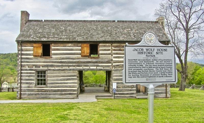 A sign outside the Jacob Wolf House gives a brief history of the site. (Special to the Democrat-Gazette/Marcia Schnedler)