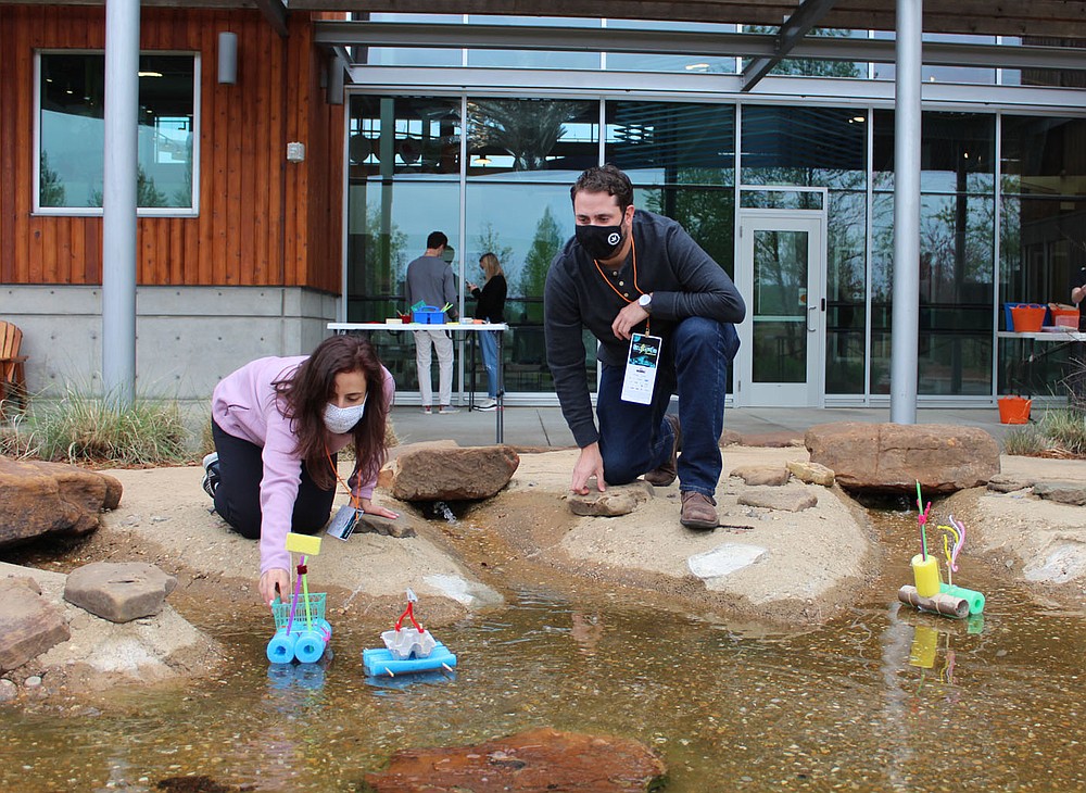 Melissa and Michael Belman launch the boats they constructed at the UnGala.
(NWA Democrat-Gazette/Carin Schoppmeyer)