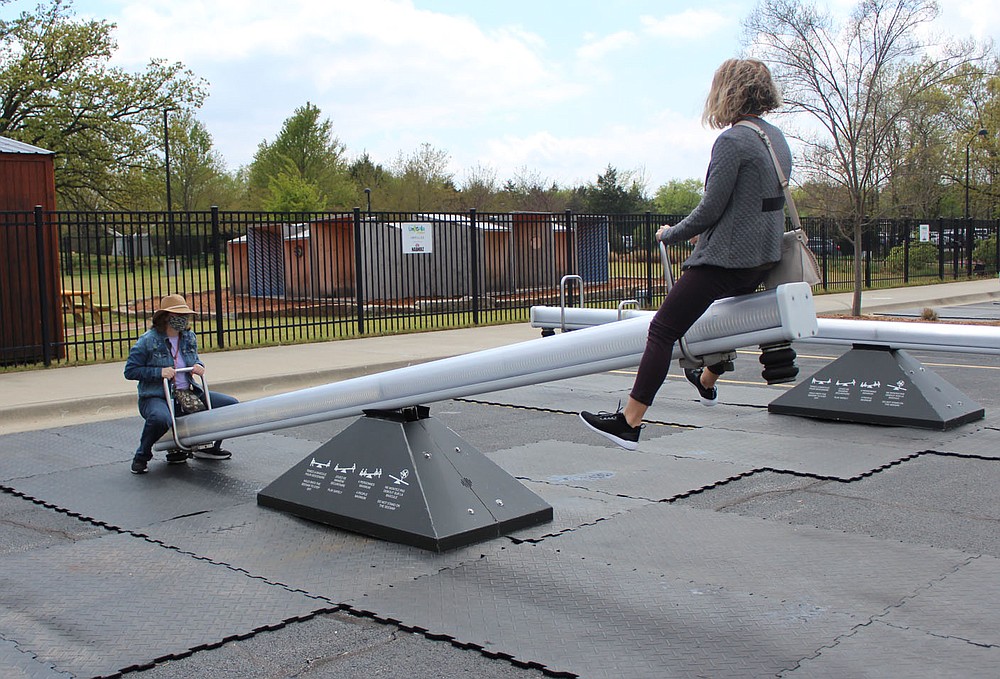 Edna Stanley (right) gets airborne as she and Dora Poage play on the Impulse seesaws installation at the Amazeum.
(NWA Democrat-Gazette/Carin Schoppmeyer)